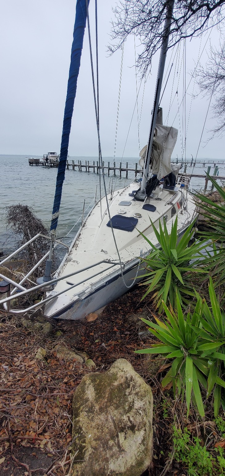 Derelict sailboat along shoreline